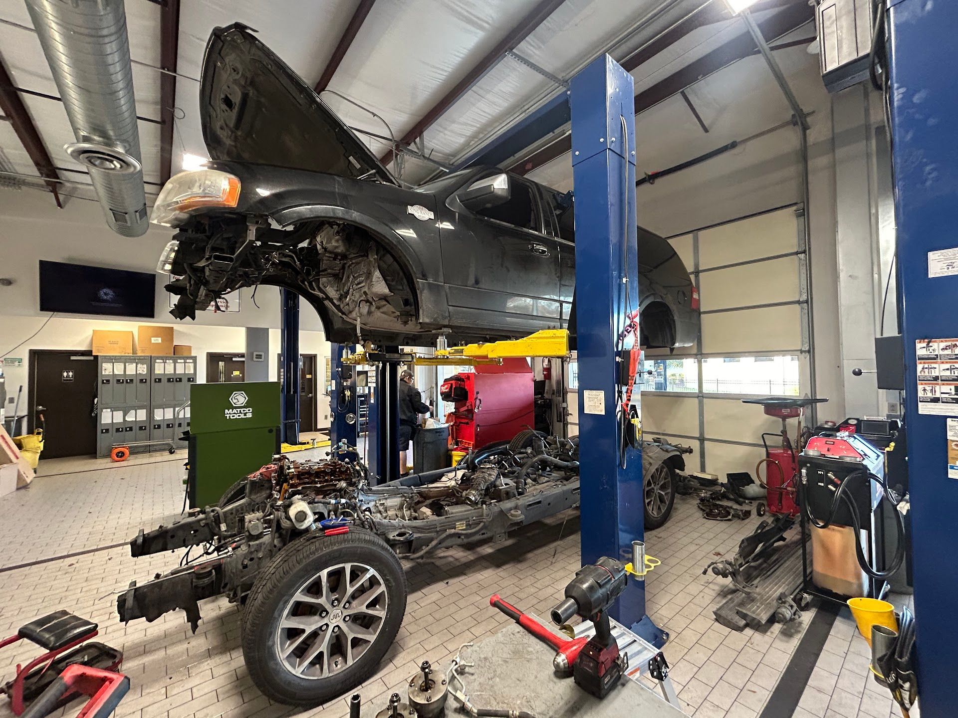 Vehicle Lifted for Engine and Frame Repair in Shop | Elite Auto Care