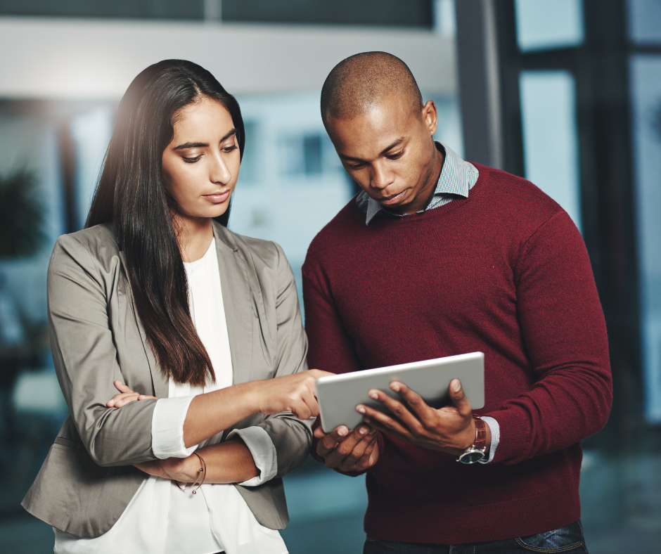 Two business people looking at tablet.