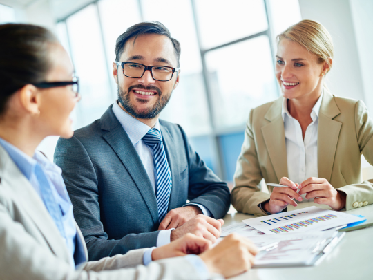 Three people in a work meeting.