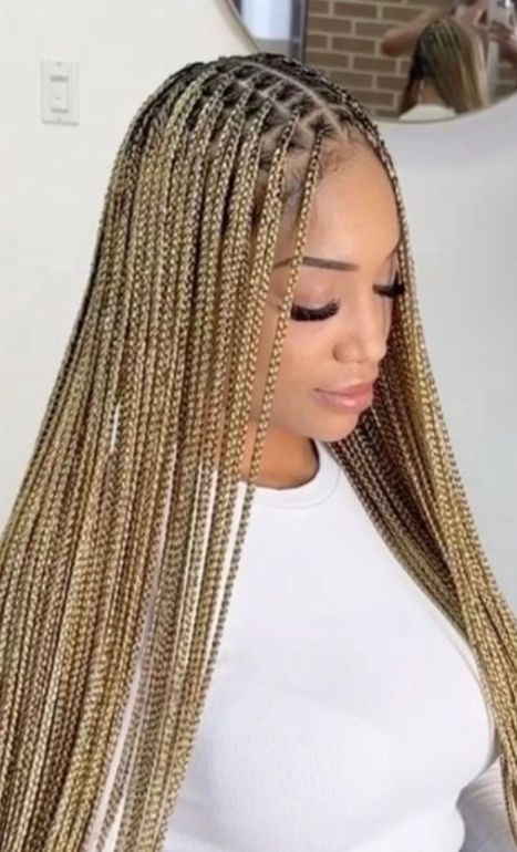 A Woman with Braids Is Wearing A Colorful Sweater