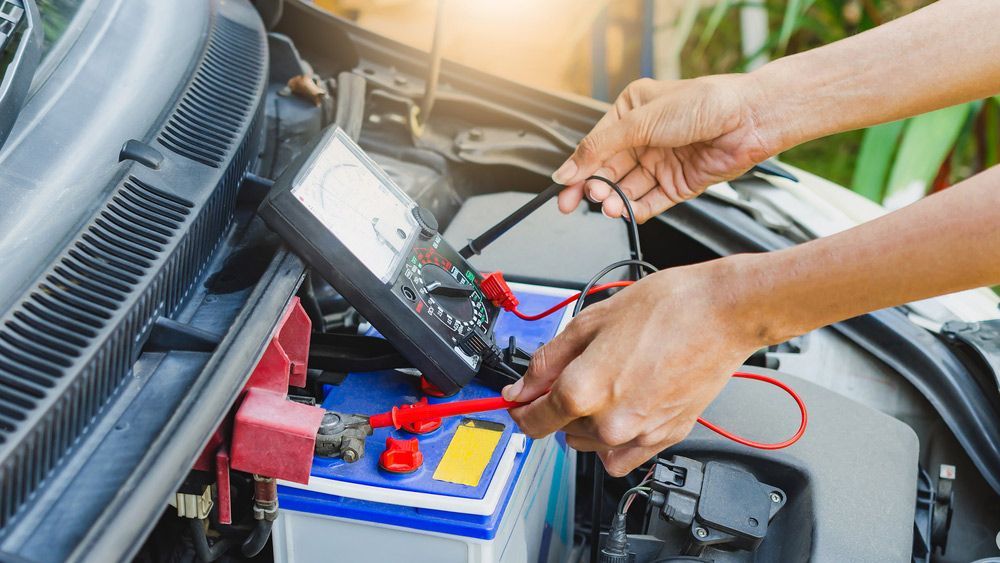Checking power of battery by meter — A Grade Oils & Batteries In Wodonga VIC