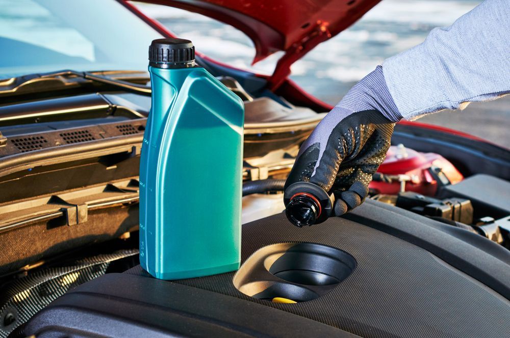 Filling engine oil in modern car — A Grade Oils & Batteries In Wagga Wagga NSW