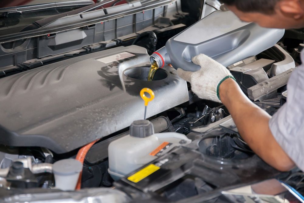 New oil lubricant into the car engine — A Grade Oils & Batteries In Myrtleford VIC