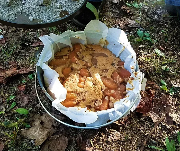 A bucket filled with food is sitting on the ground