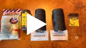 A bunch of fishing gear is sitting on a table.