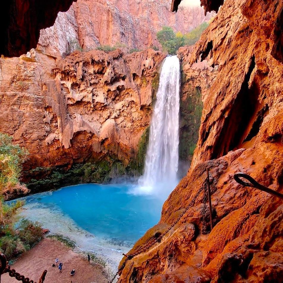 A waterfall with a blue pool in the middle of it