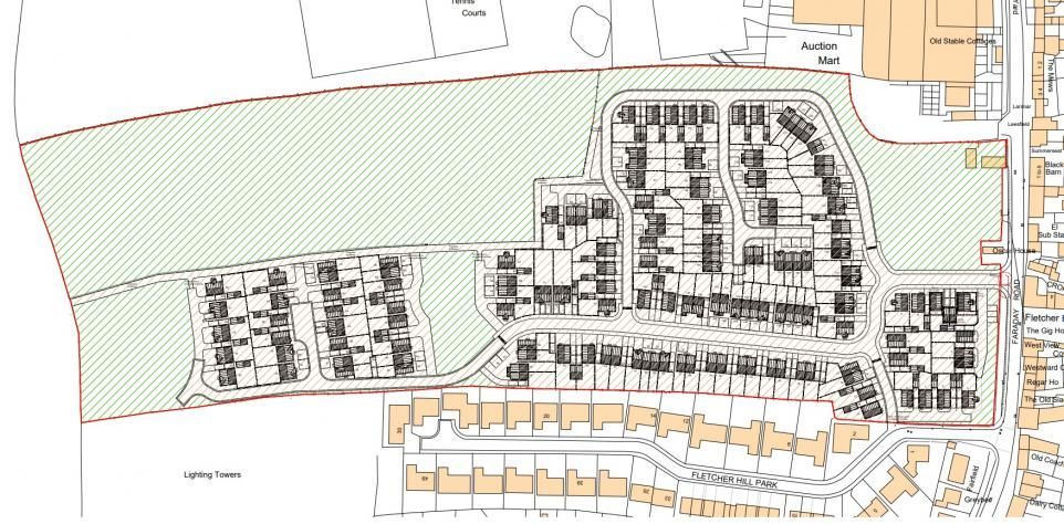 Map of proposed housing development, showing planned roads and buildings in a green field area.