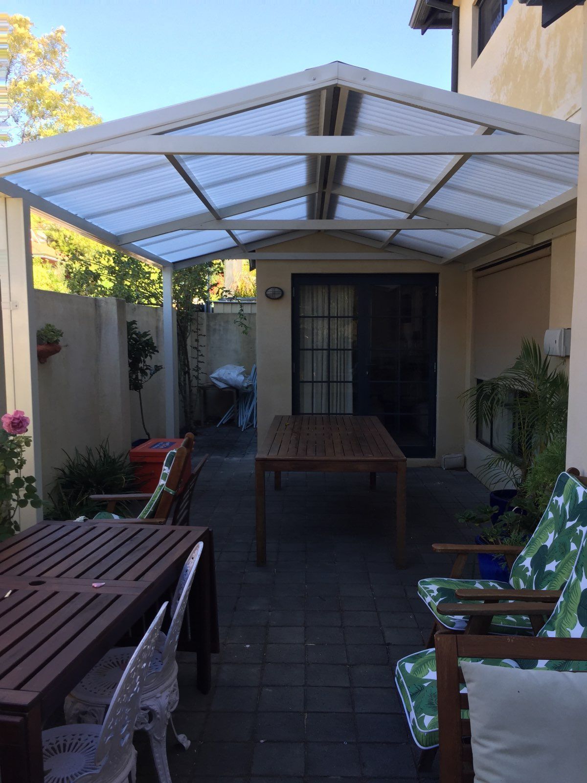House patio with wooden table below | Carine, WA | Modern Plastics & Pergolas
