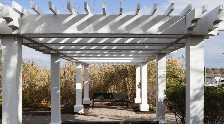 A white pergola with long chair | Carine, WA | Modern Plastics & Pergolas
