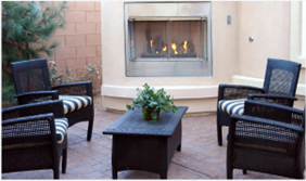 A stylish patio showcasing a fireplace and chairs, designed by patio contractors in Perth.