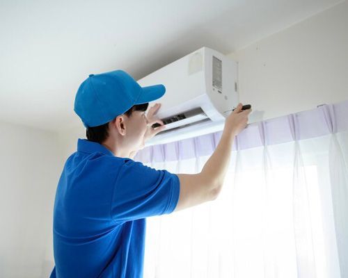 Arctic Fox technician is installing an air conditioner in a room.