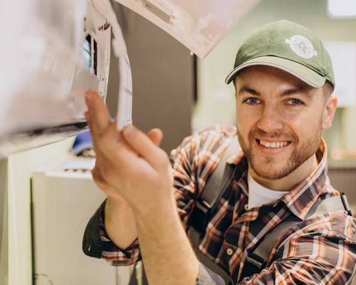 A man in a plaid shirt and hat is holding a piece of paper.