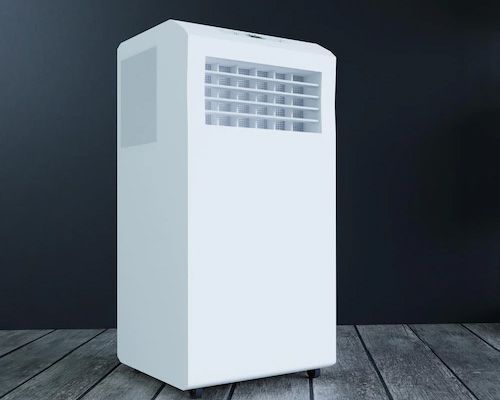 A white portable air conditioner is sitting on a wooden floor.
