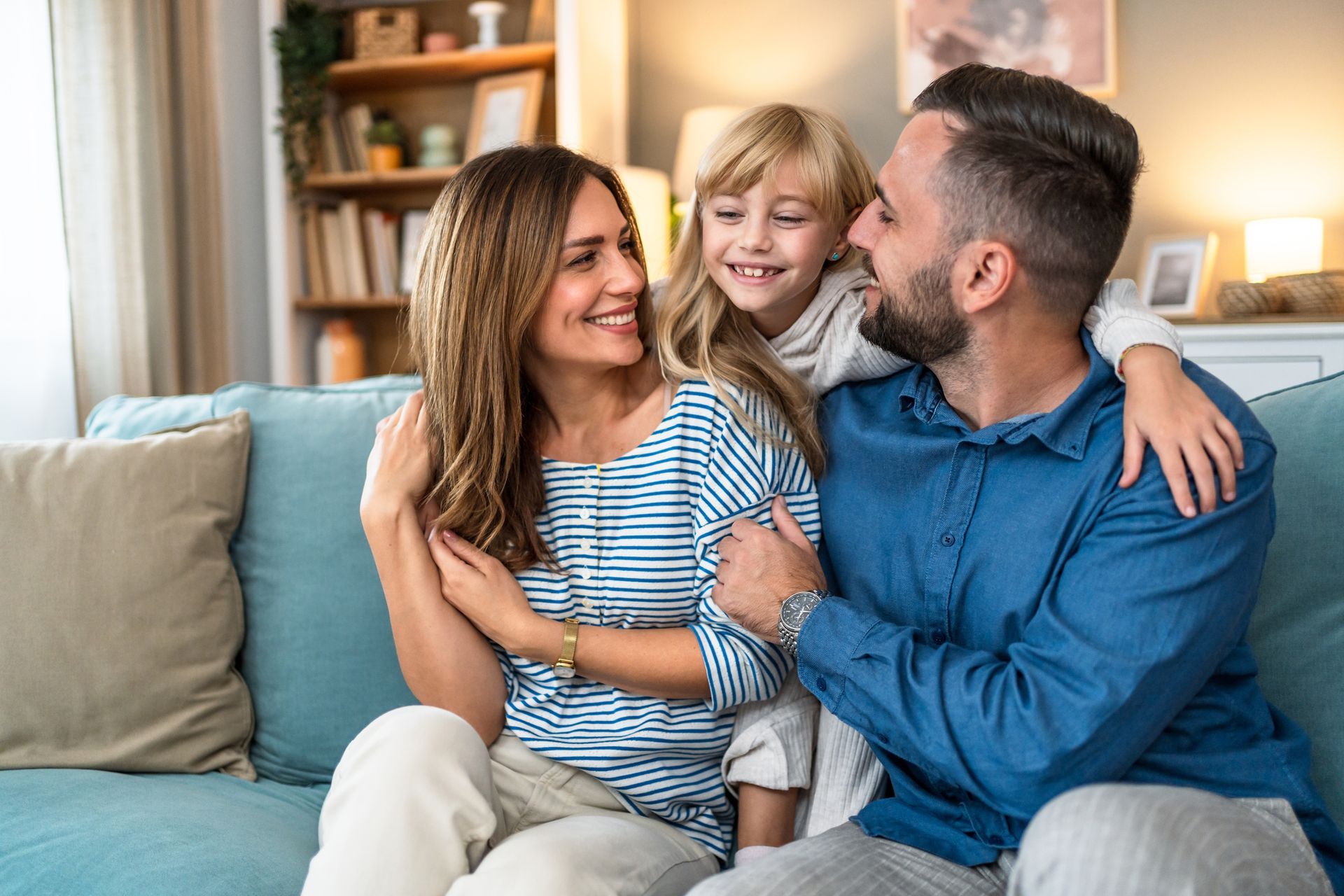 Happy family on the couch after indoor air quality check from Arctic Fox Cooling.