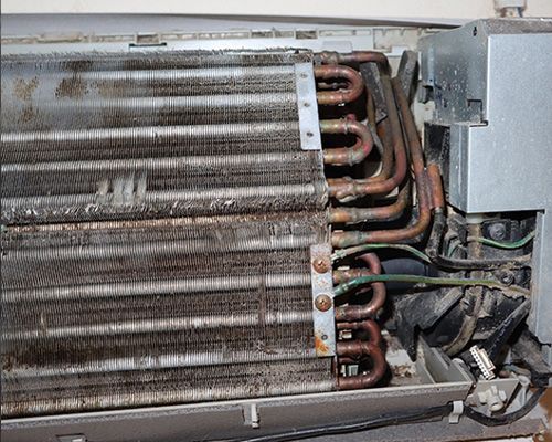 A close up of a dirty air conditioner 's evaporator.