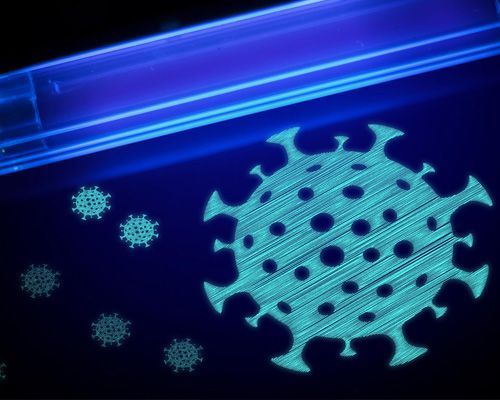 A picture of a virus glowing in the dark under a uv light.