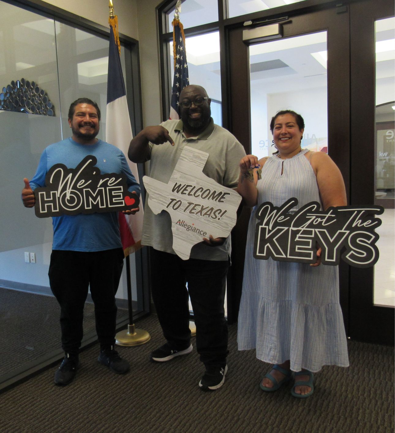 Three people holding signs that say 