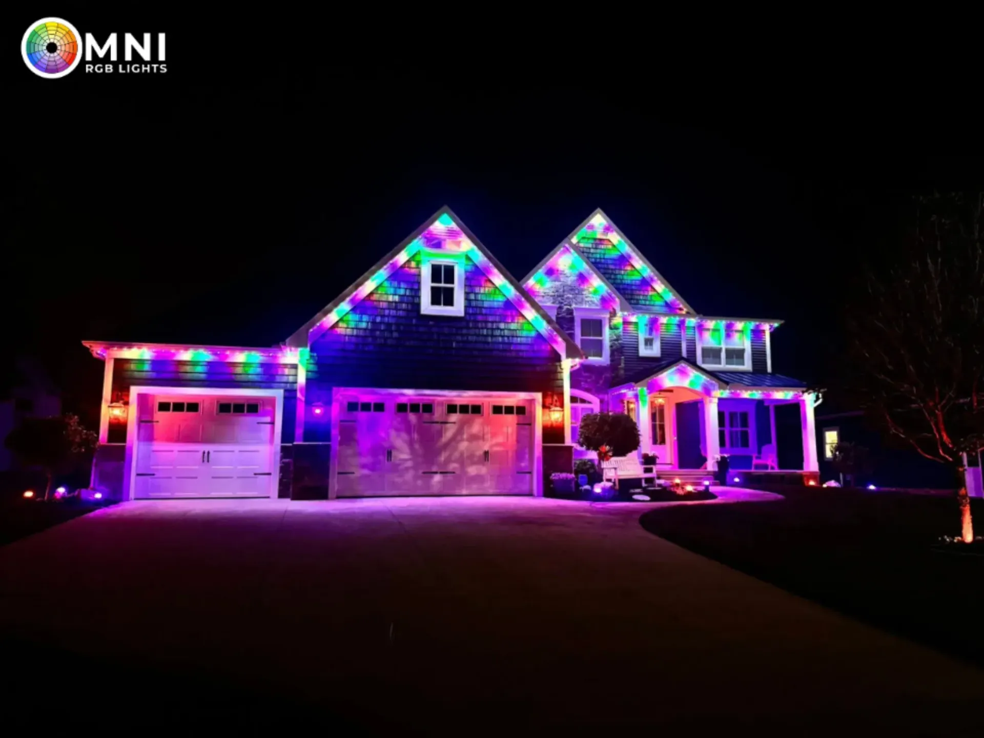 House lit with colorful pink, purple, and blue Christmas lights at night