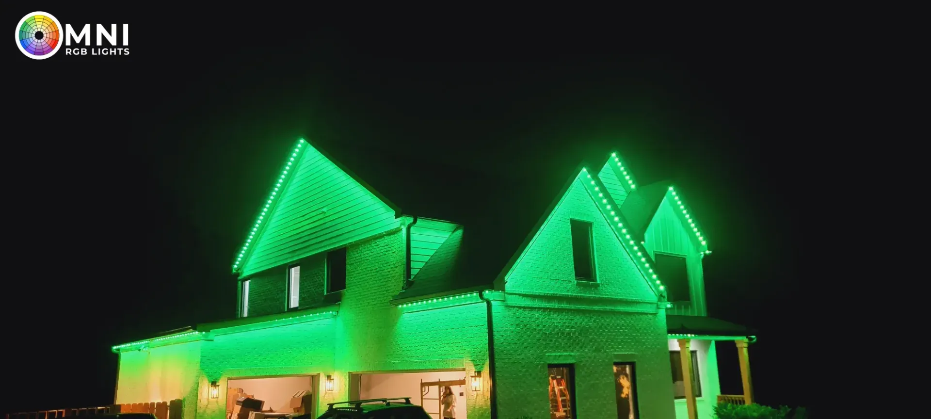 House outlined with bright green lights at night