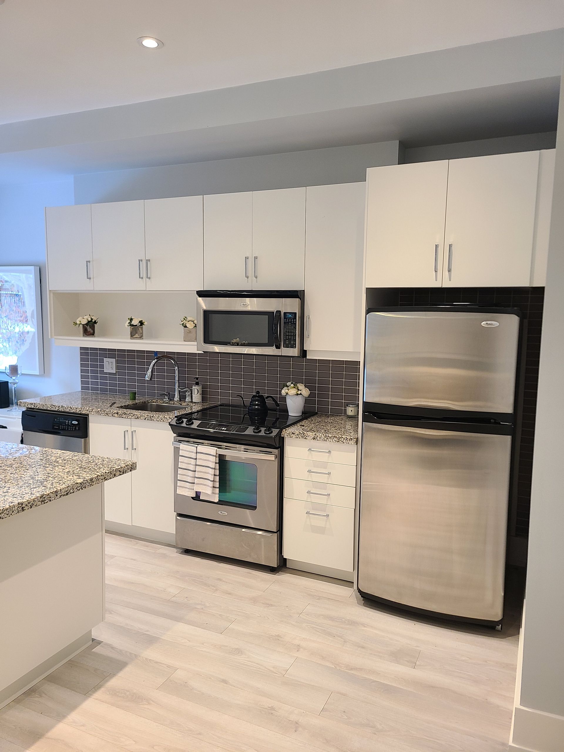 White kitchen cabinets wrapped in matte white vinyl