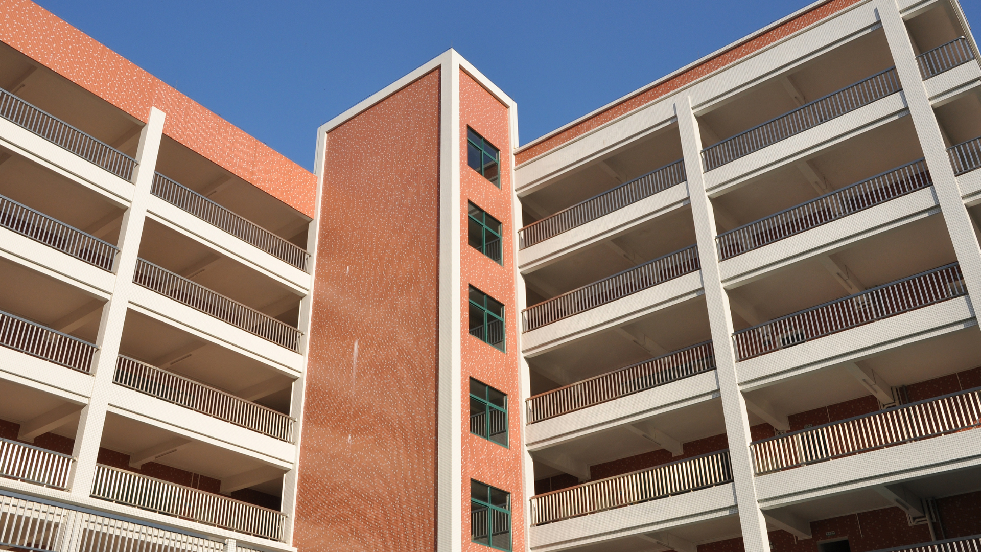 A brick building with a lot of balconies and stairs