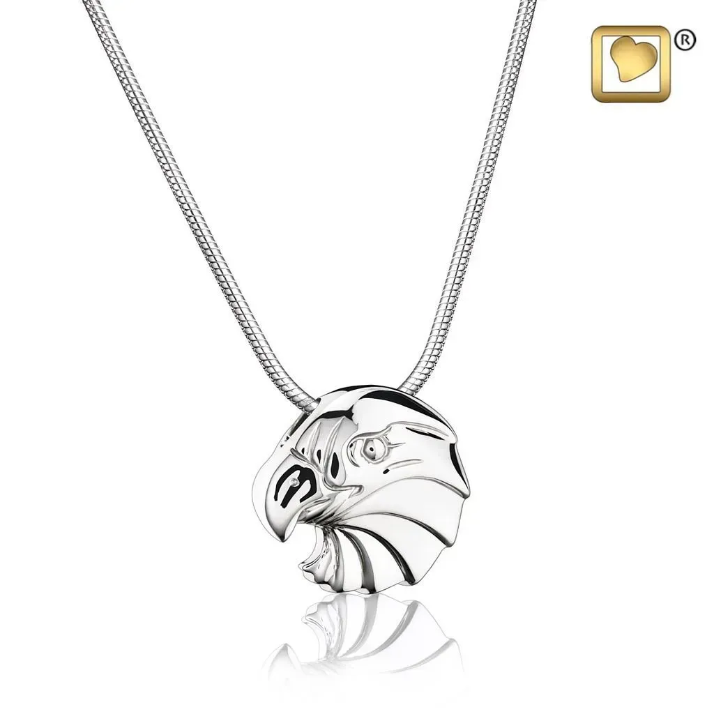 Silver eagle-head pendant necklace on a chain, with a small gold logo in the corner