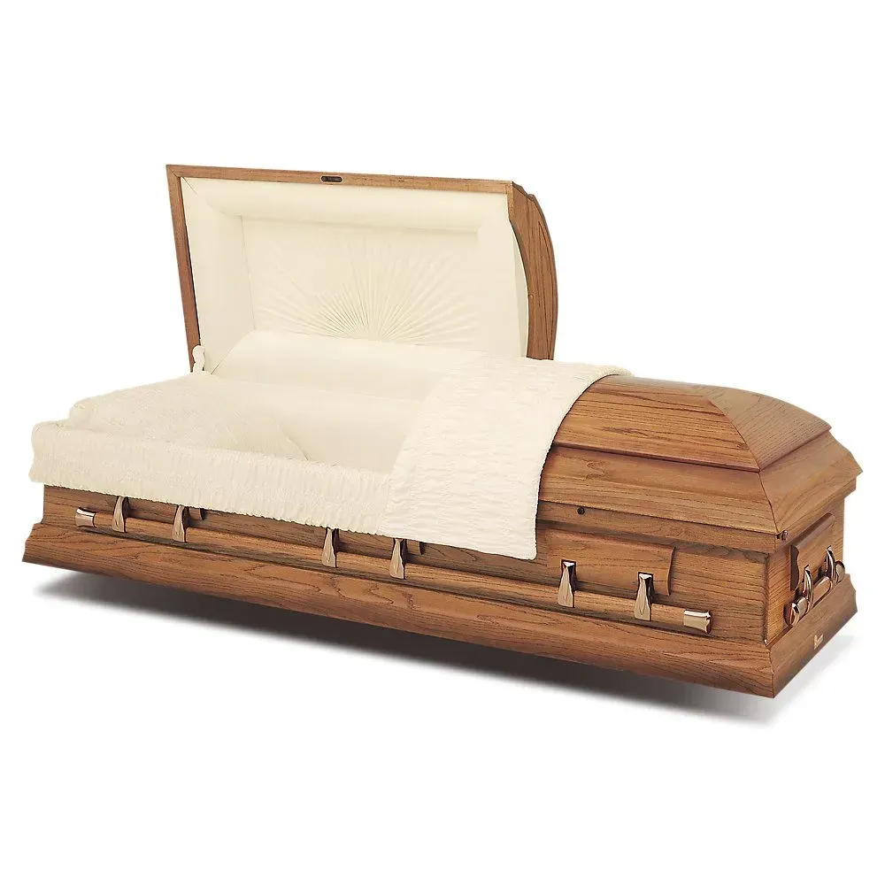 Wooden coffin shaped like a couch with white upholstery and an open lid