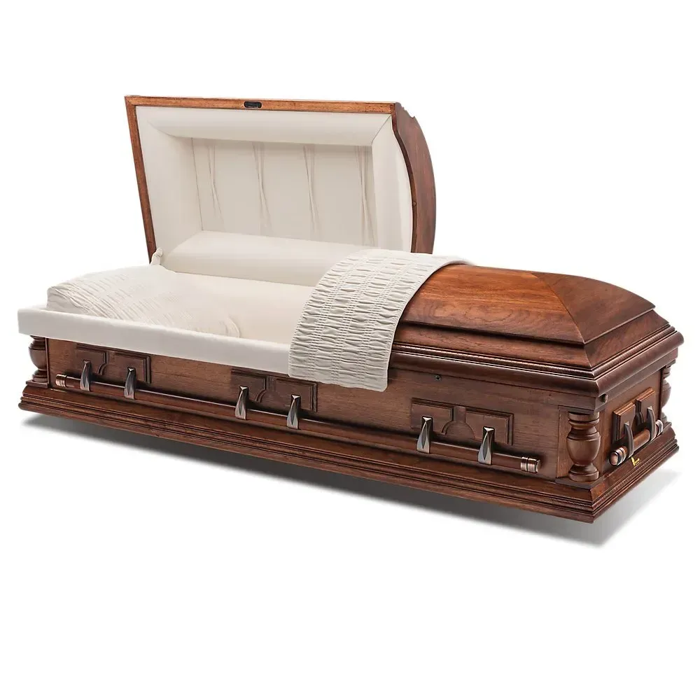 Open wooden casket with cream satin lining and white embroidered pillow