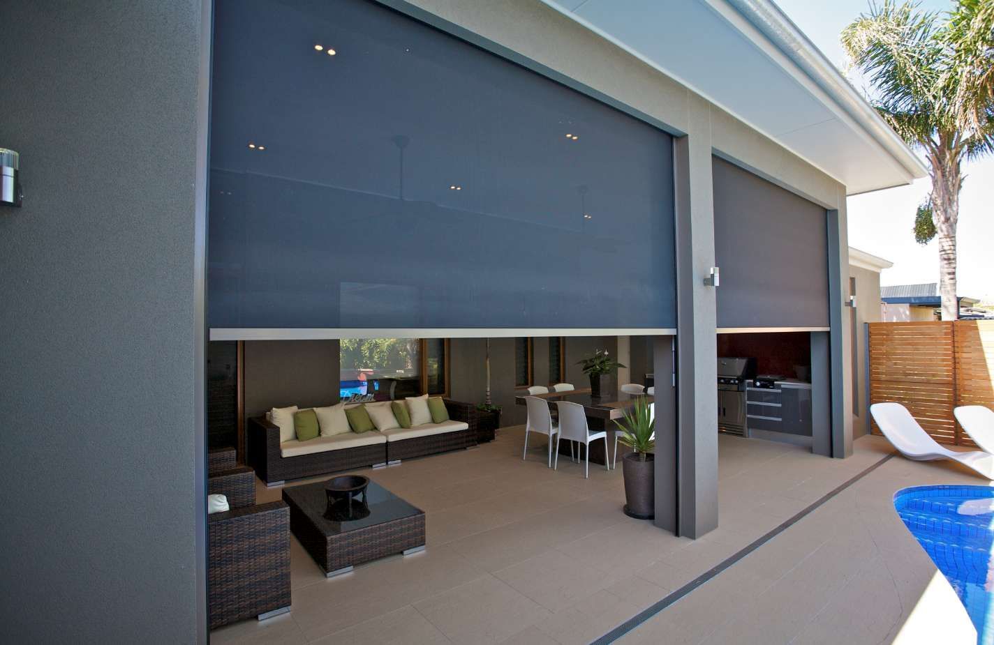 A patio with a couch and chairs and a table