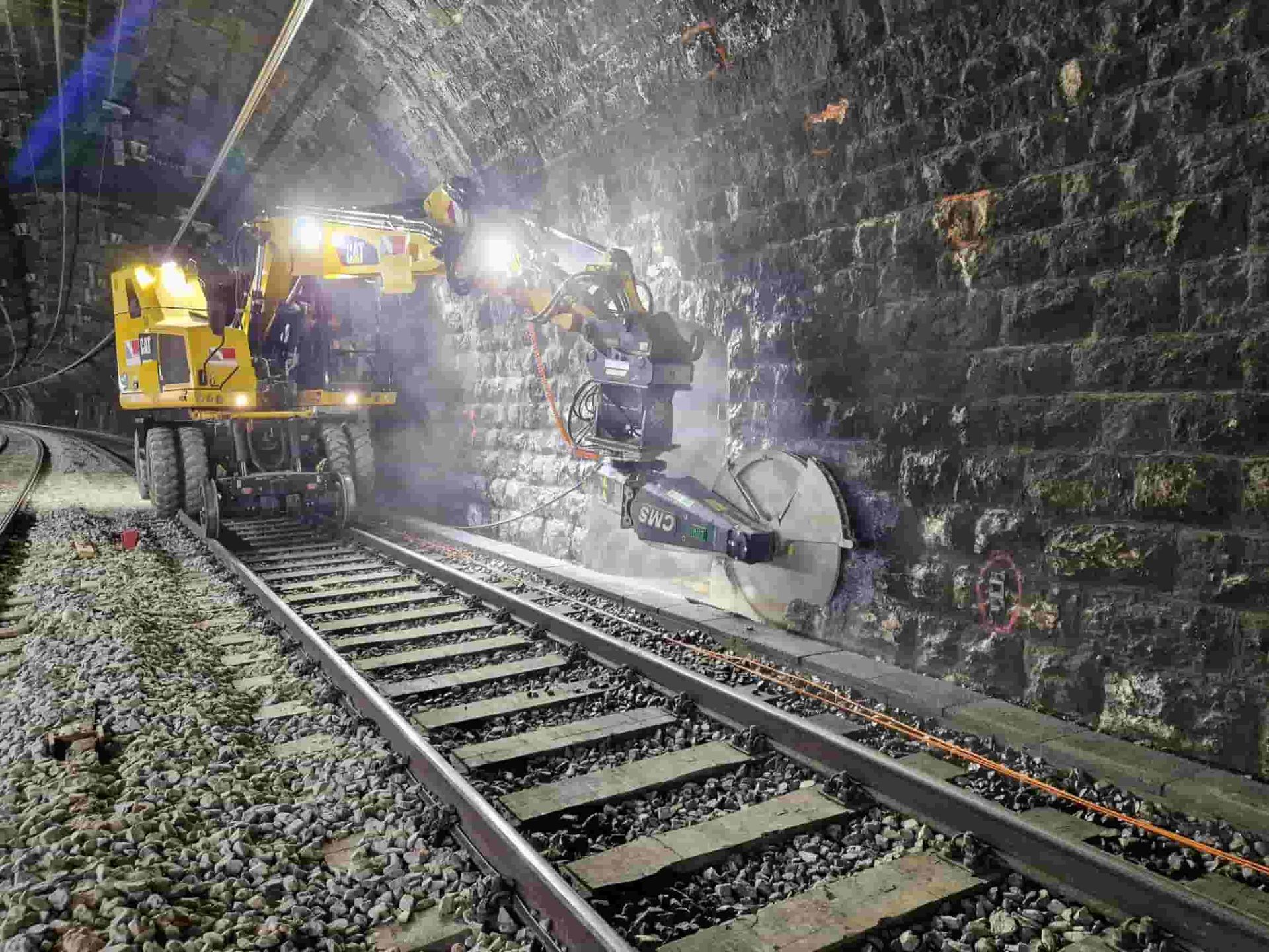 Egli excavator saw cutting concrete alongside the tracks in a railway tunnel, supplied by Harrybilt Engineering