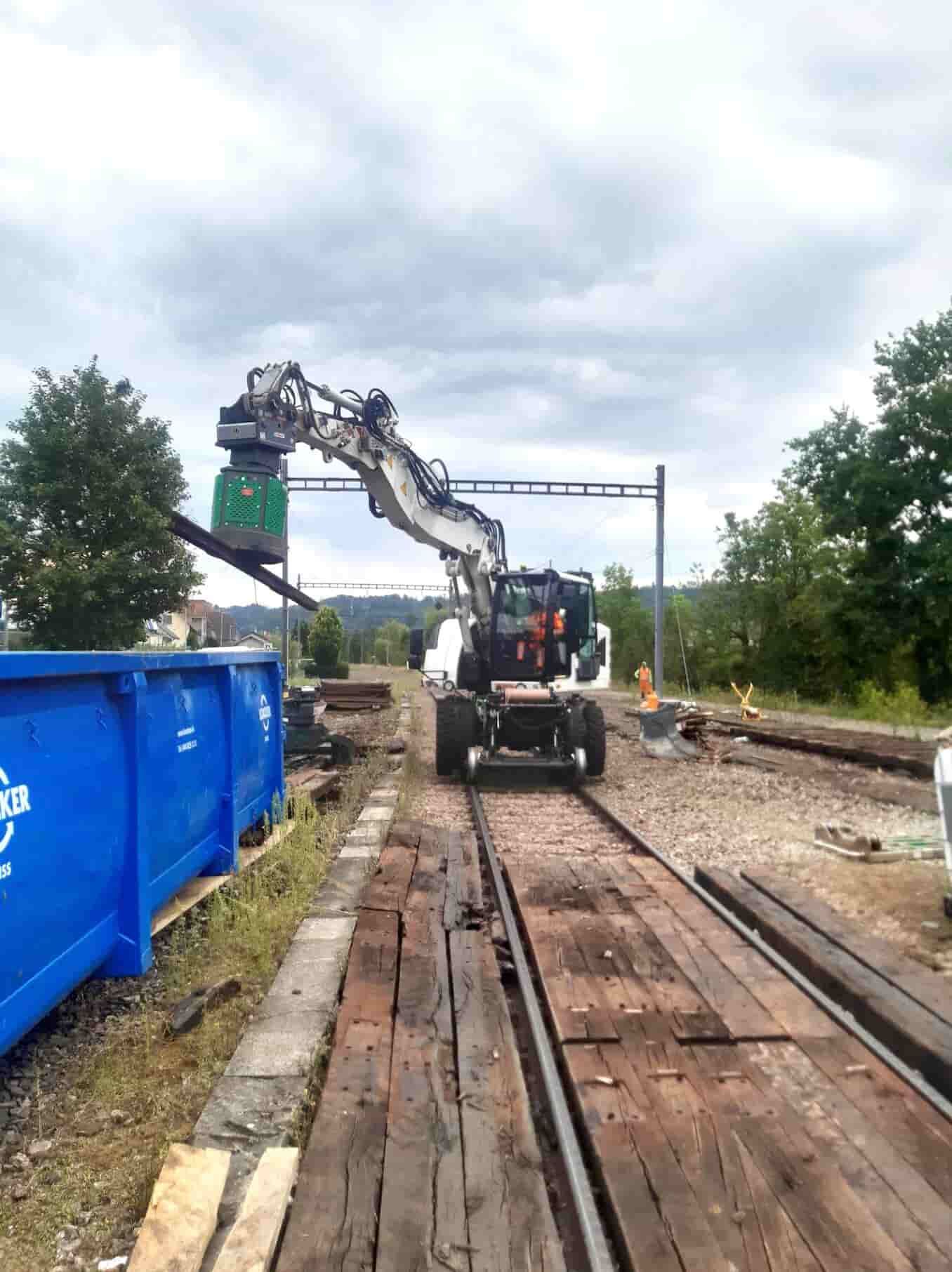 Egli hydraulic magnet lifting a section of scrap rail into a disposal skip during rail removal works, supplied by Harrybilt Engineering