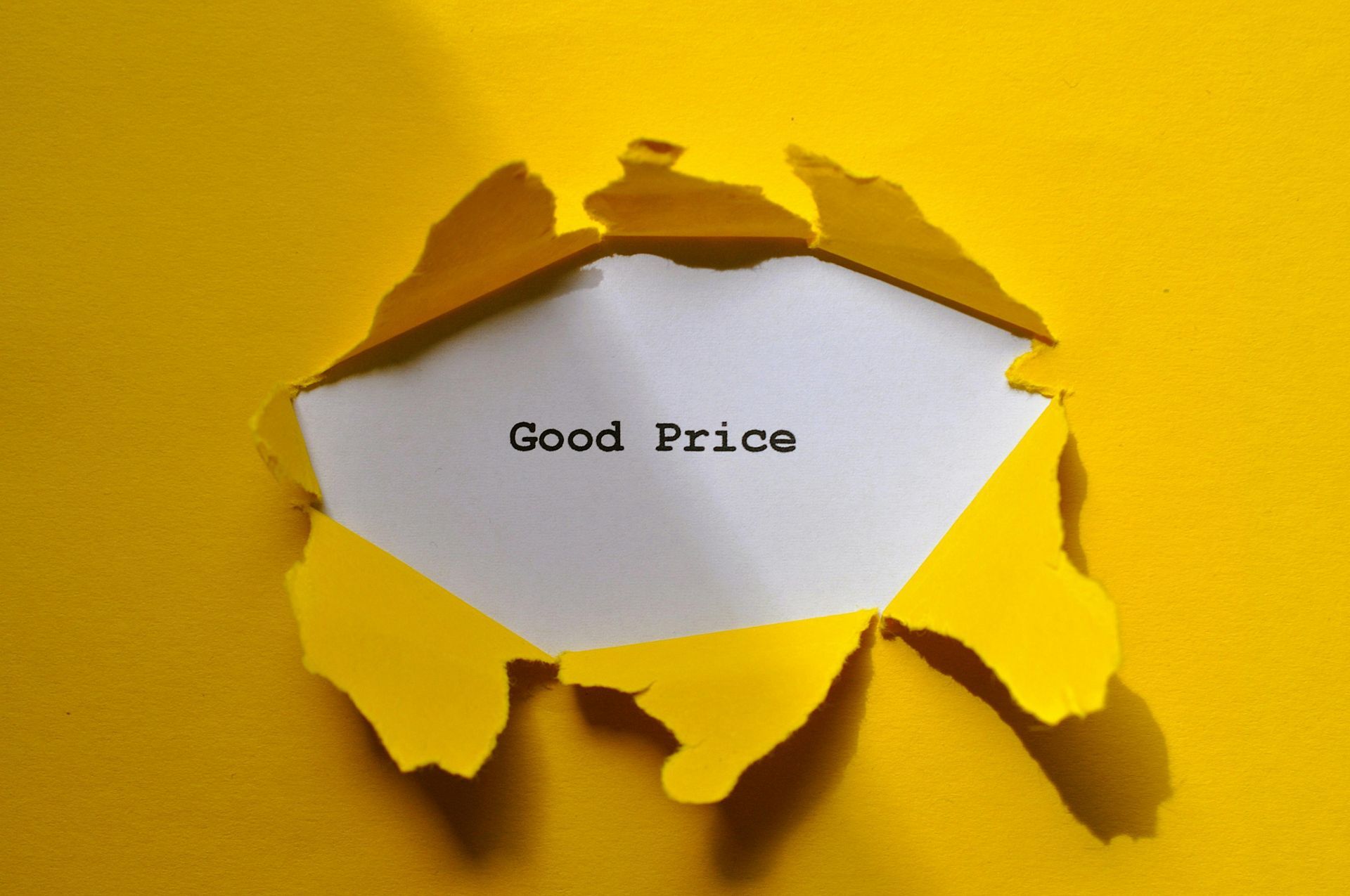 Yellow paper torn to reveal white space with 