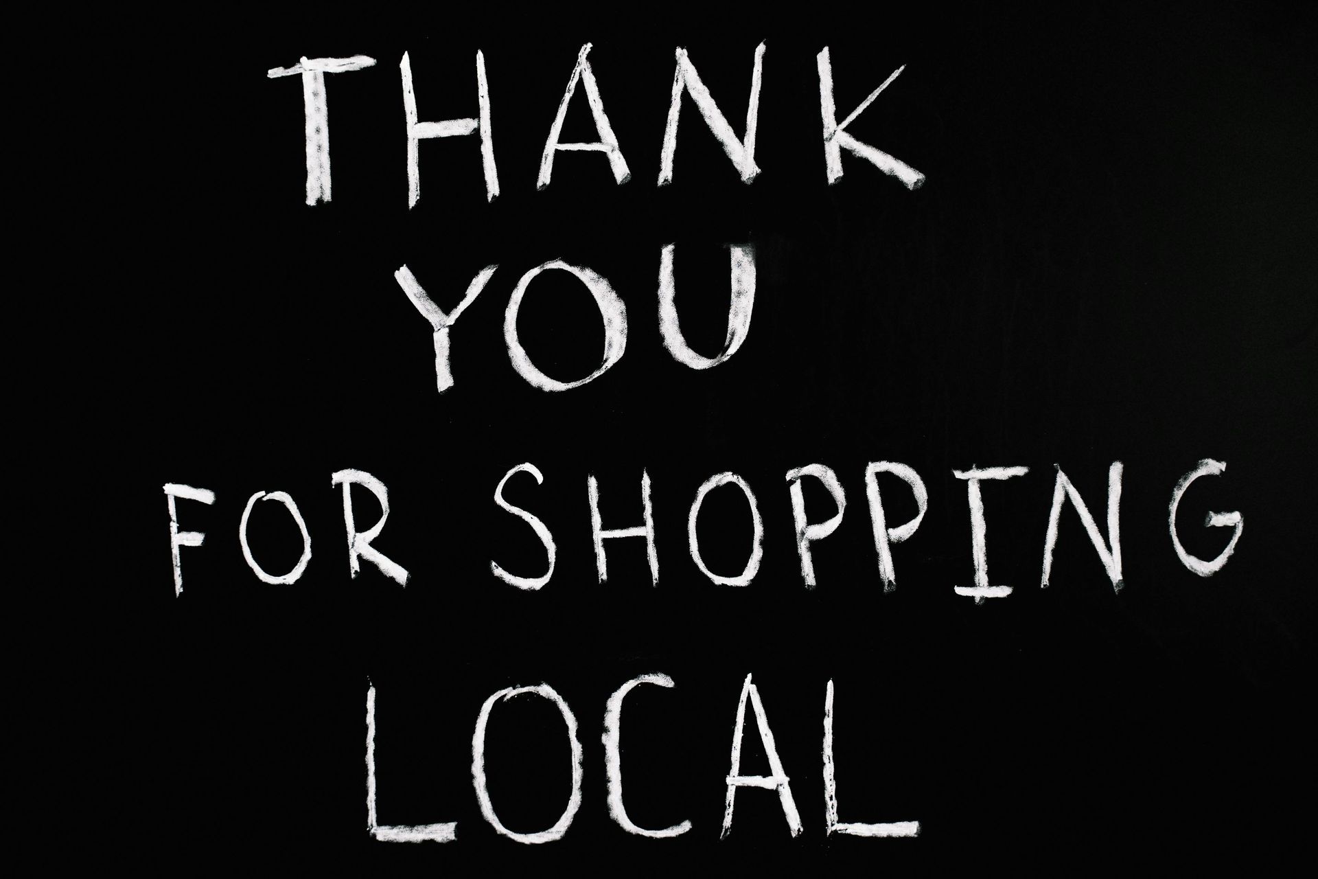 A sign that says thank you for shopping local