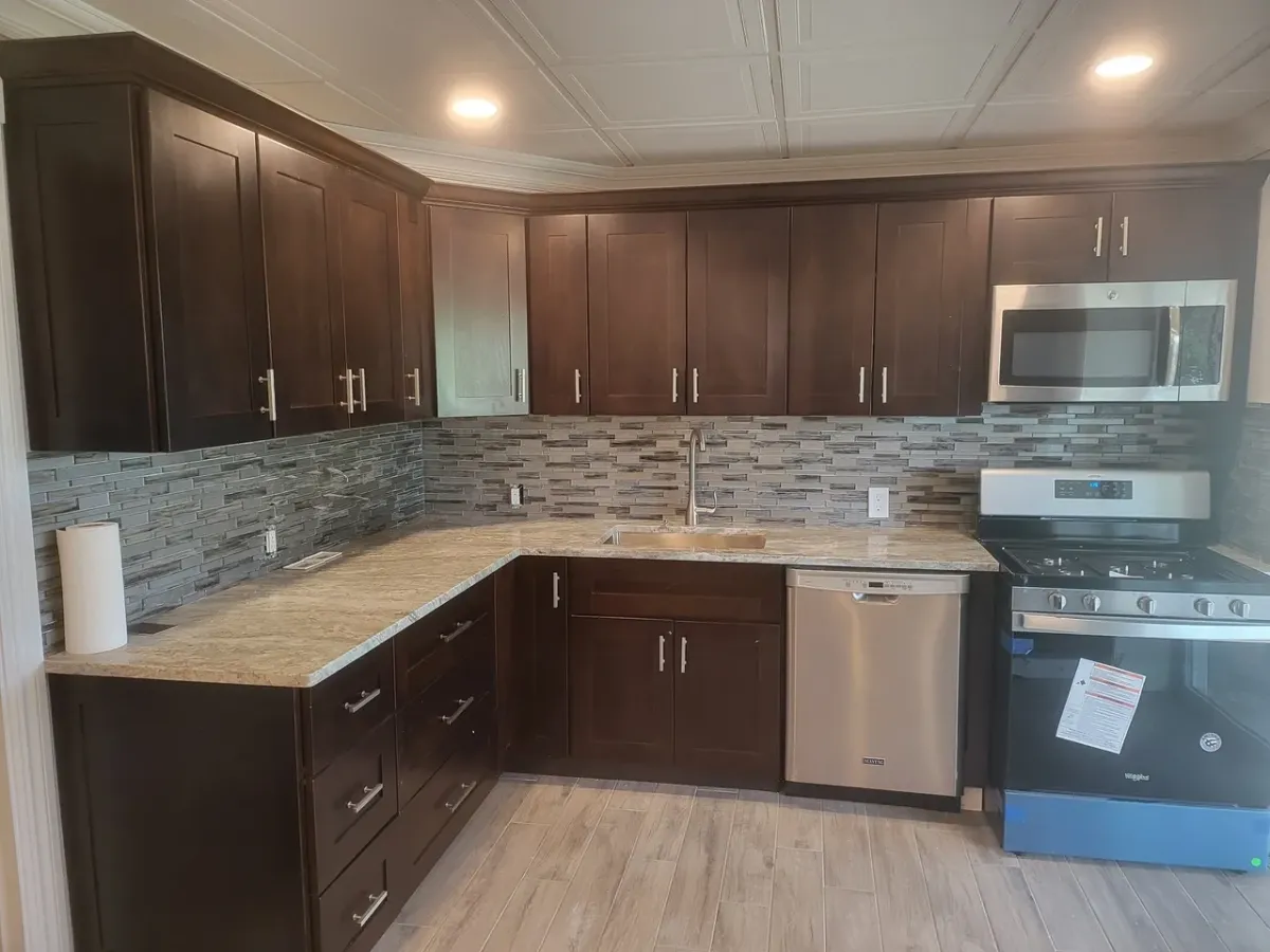 A kitchen with stainless steel appliances and wooden cabinets.