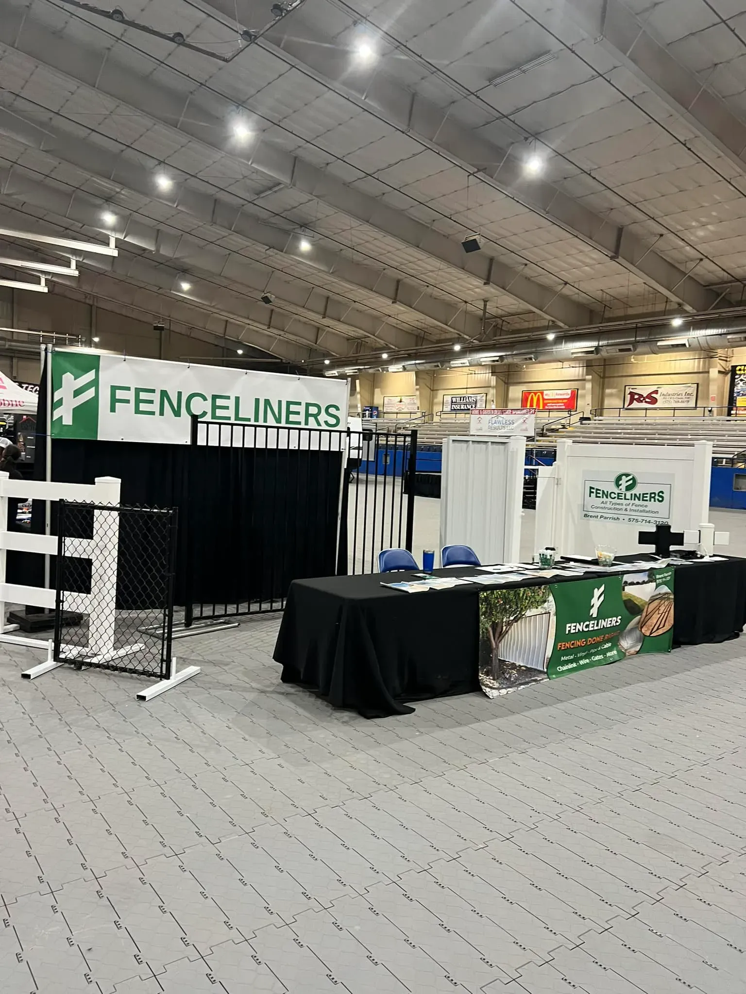 A fenceliners booth in a large building