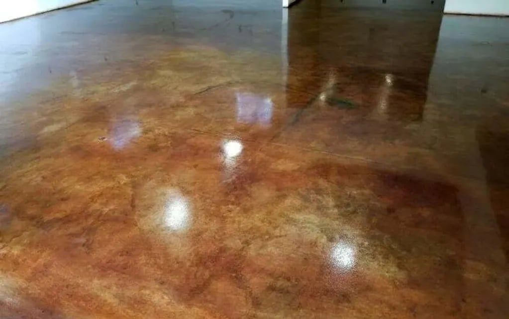 Shiny brown polished floor reflecting ceiling lights in an empty room