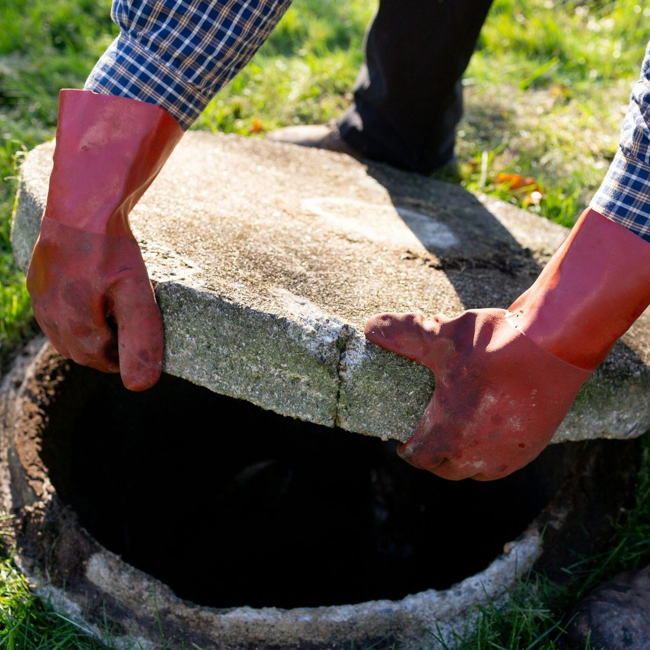 Man Holding Septic Cover - Sumter, SC - T & N Septic Tank Co.