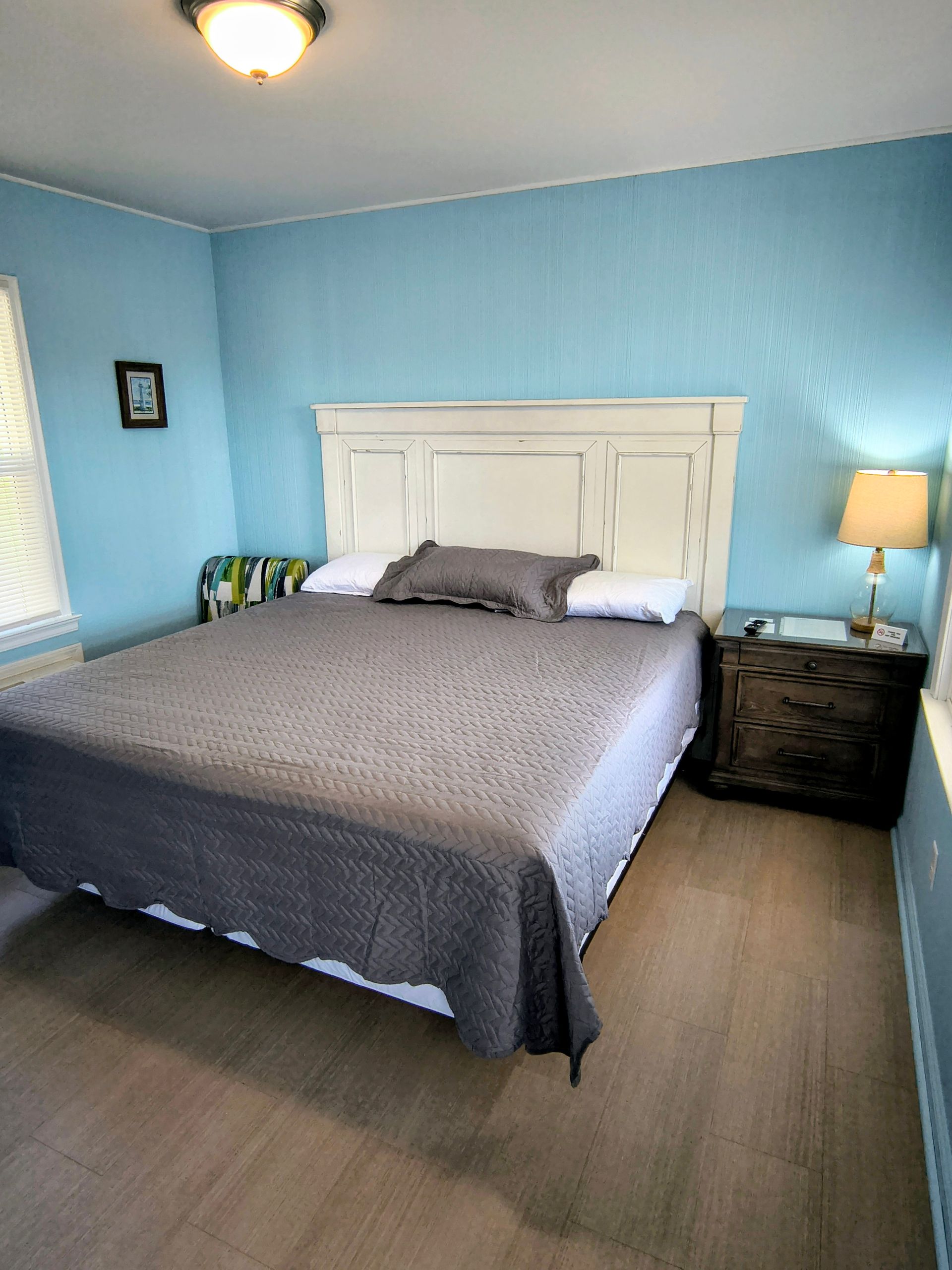 Laptop on a bed with pillows and a blue rectangle that says 