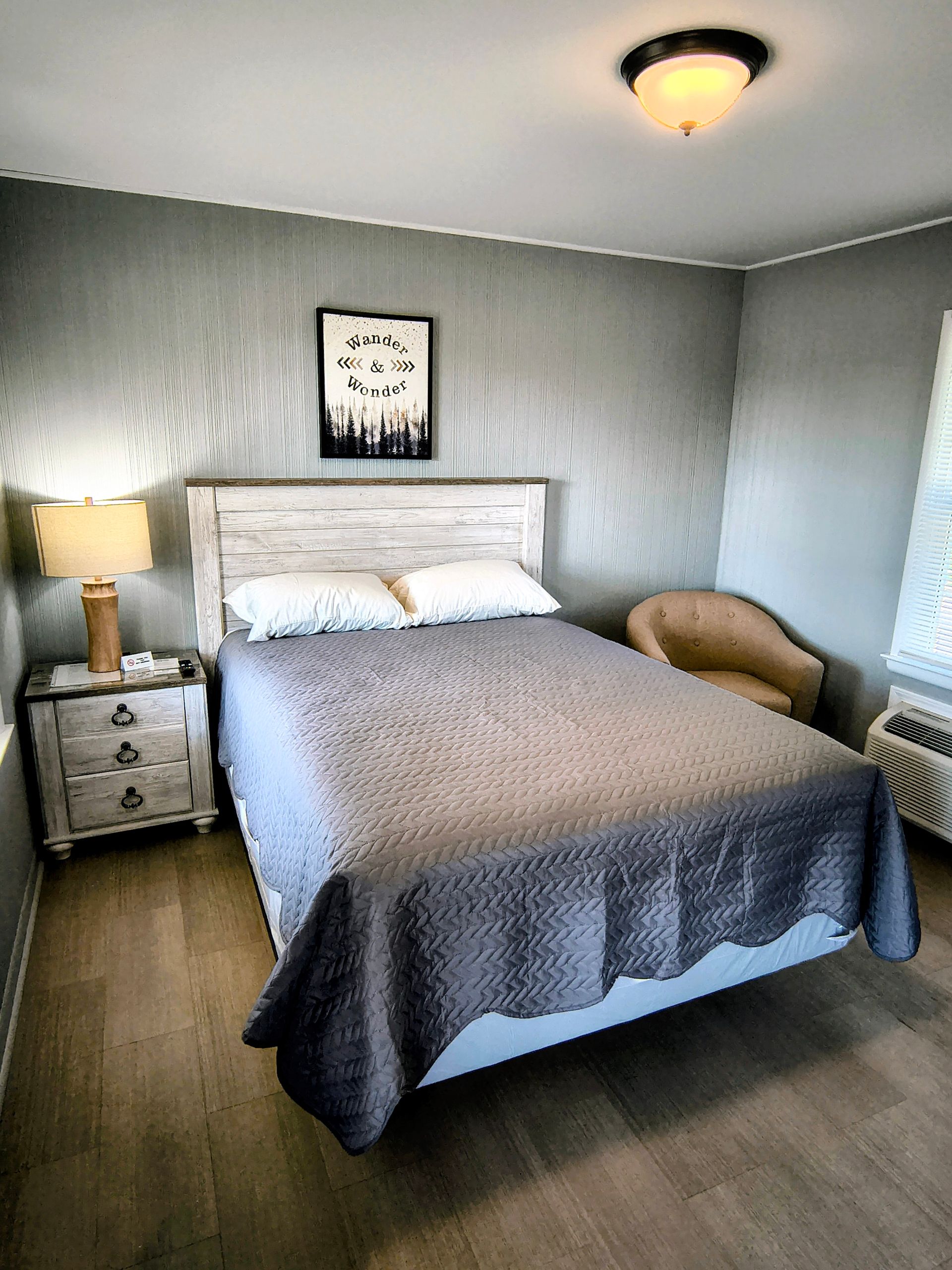Laptop on a bed with pillows and a blue rectangle that says 
