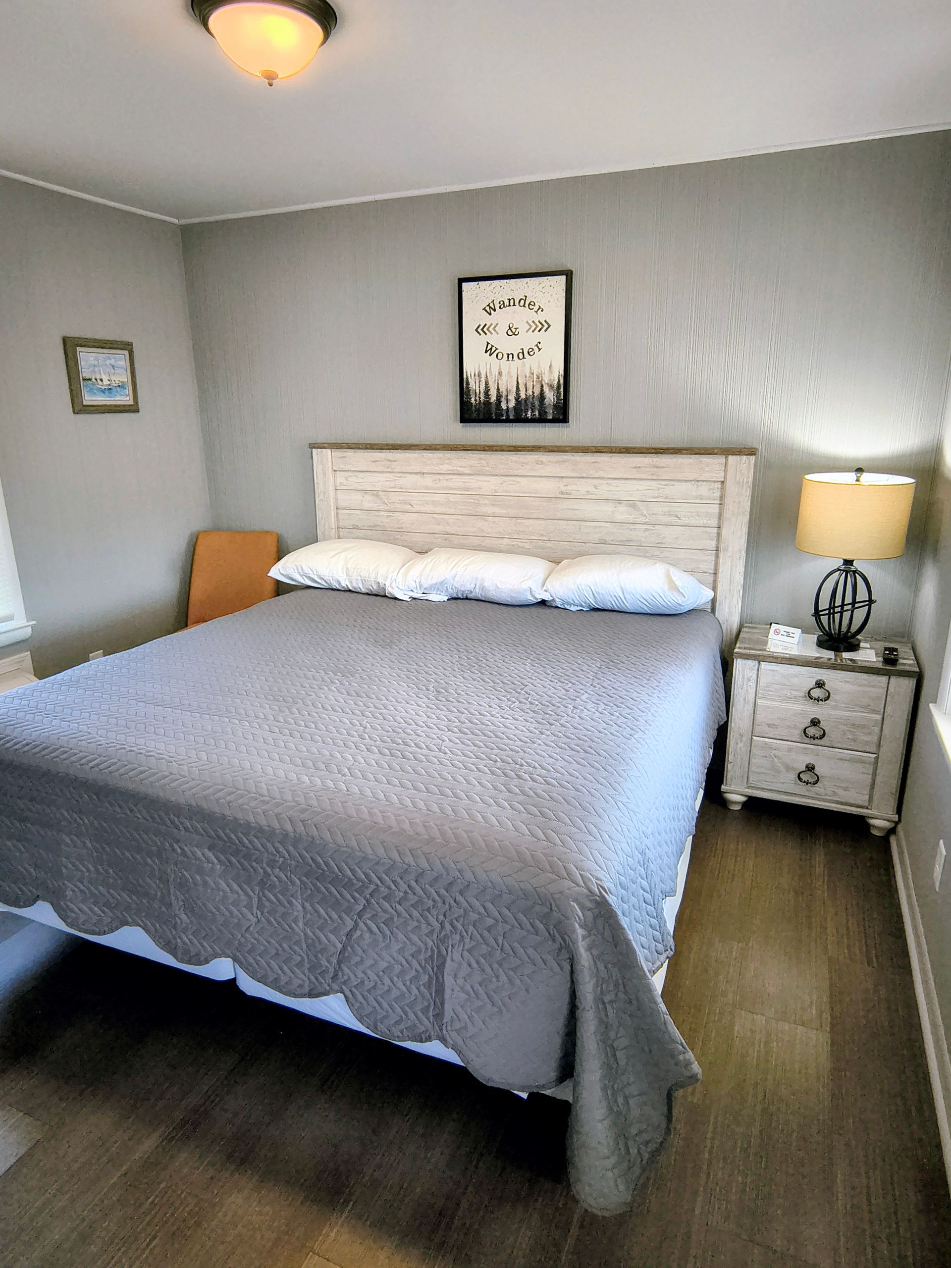 Laptop on a bed with pillows and a blue rectangle that says 