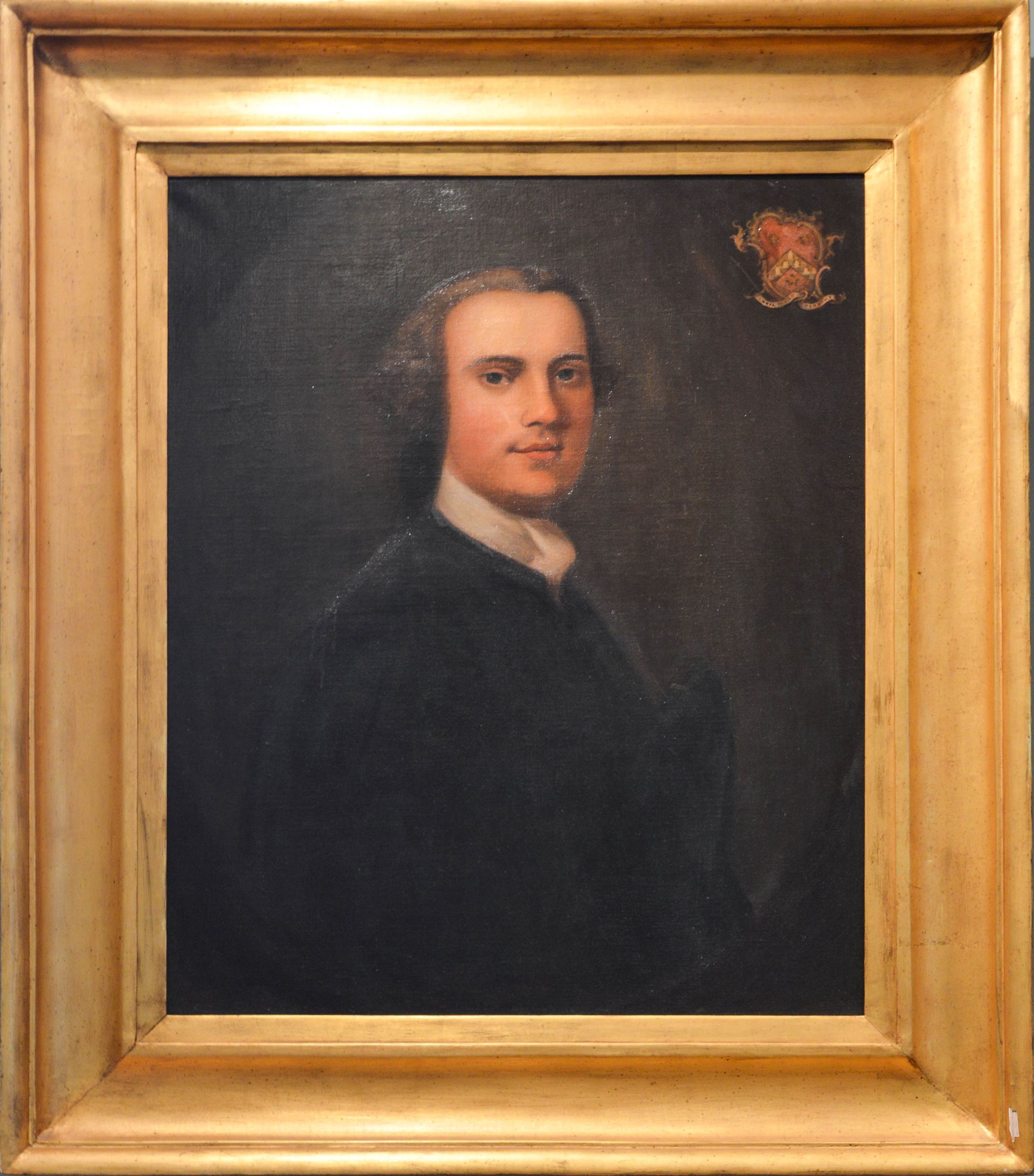 Framed dark portrait of a man in a black coat against a dark background