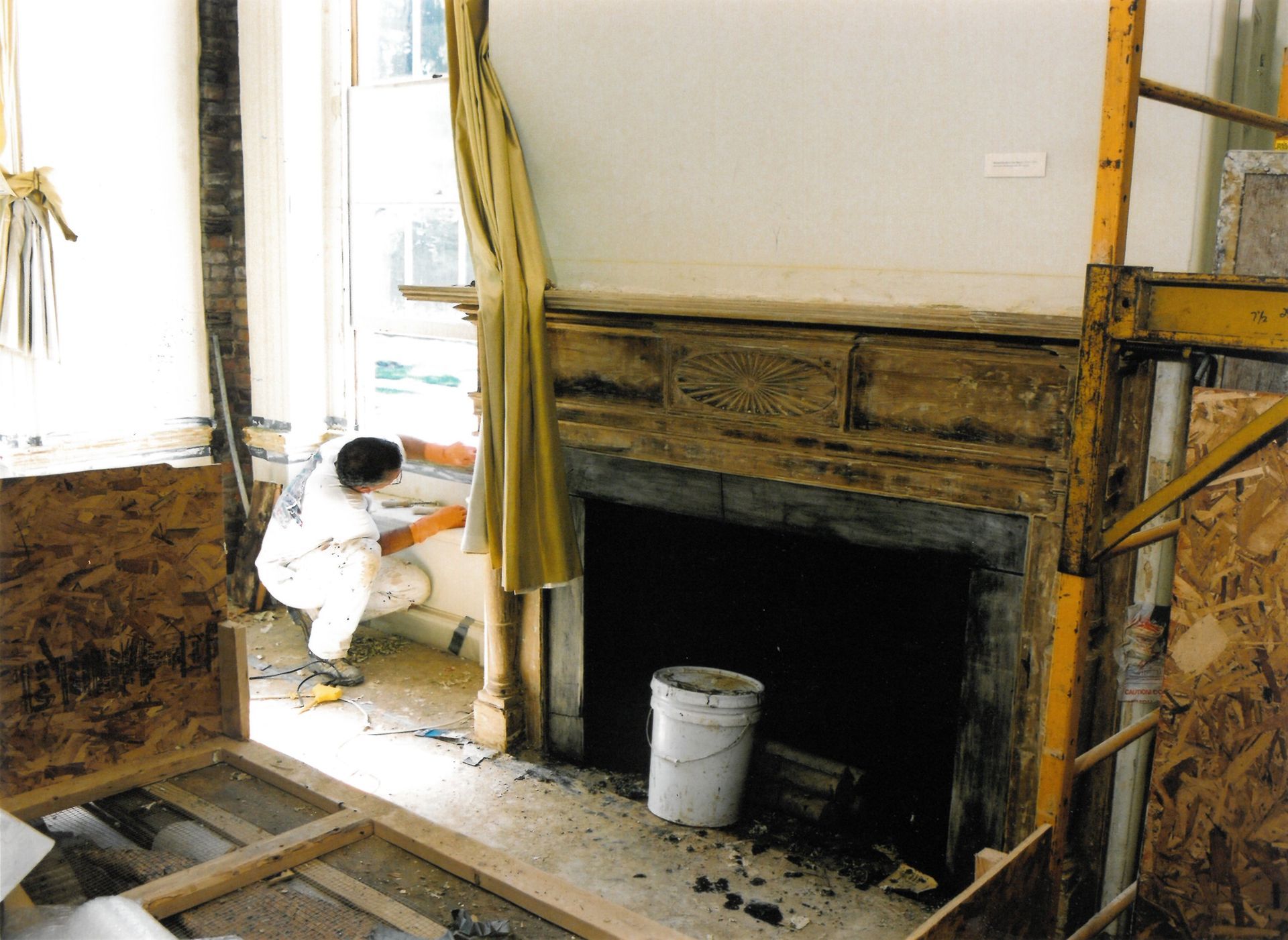 A man working near the stripped down mantle of the Dining Room during the second phase of restoration, 2002. Photograph by Thomas Gralish. Morven Archive.