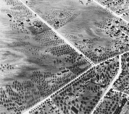 Black and white bird's-eye view of a town, showing streets, buildings, and trees.
