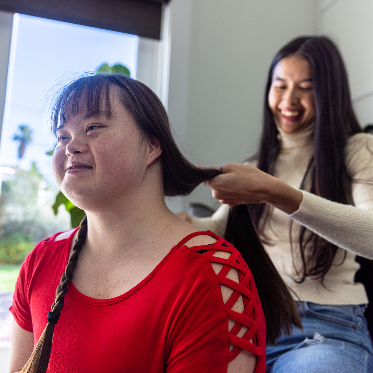 Elleisha's Property Services and Support (EPSS) NDIS personal care support worker in Wollongong brushing a participant's hair