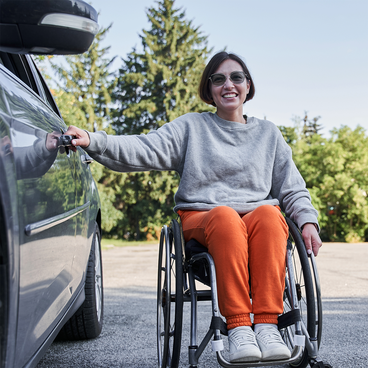 Elleisha's Property Services and Support (EPSS) is helping an NDIS participant in Wollongong with transport assistance- a participant in a wheelchair beside a car