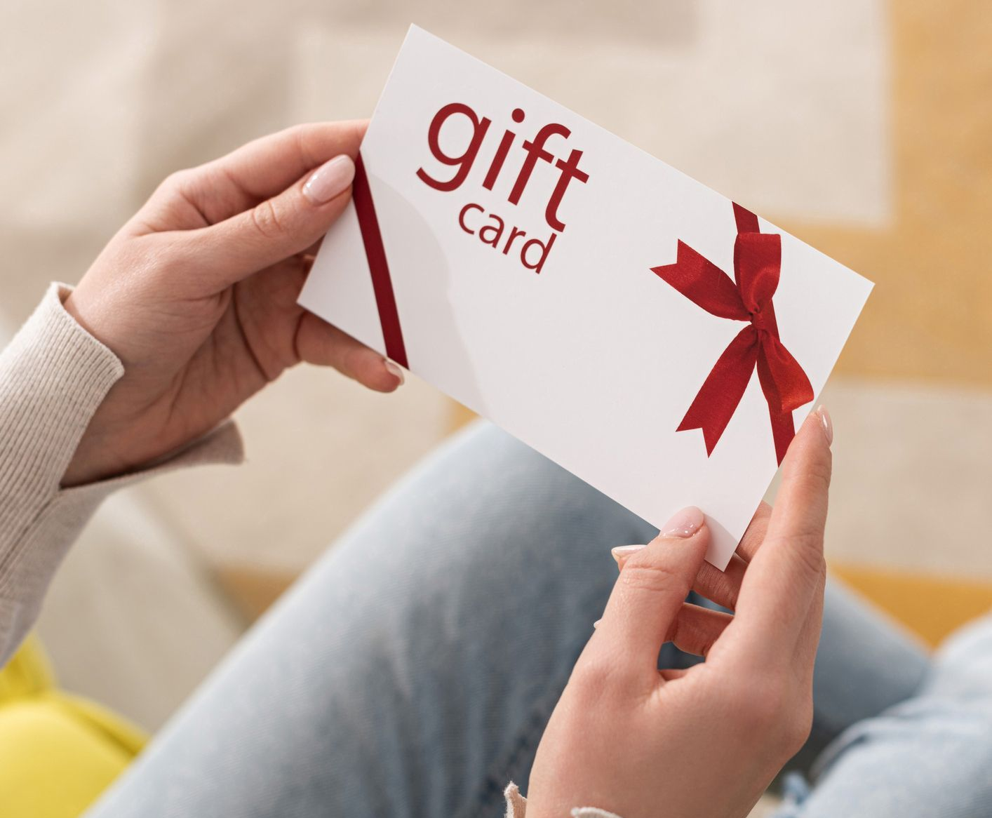 Lady holding a gift card for cleaning services in Wollongong from Elleisha's Property Services & Support (EPSS)
