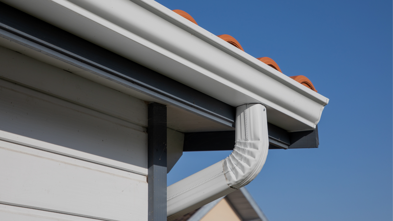 Gray metal roof with matching gutter system, viewed from a low angle.