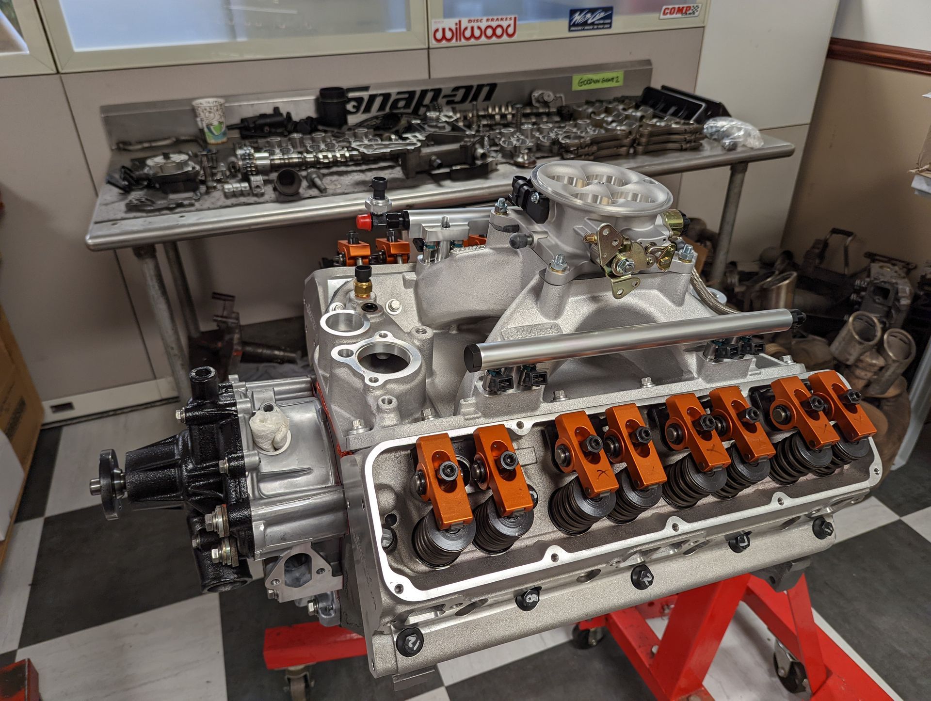 Engine assembly on a stand; components on a workbench in a workshop. | Autobahn Performance