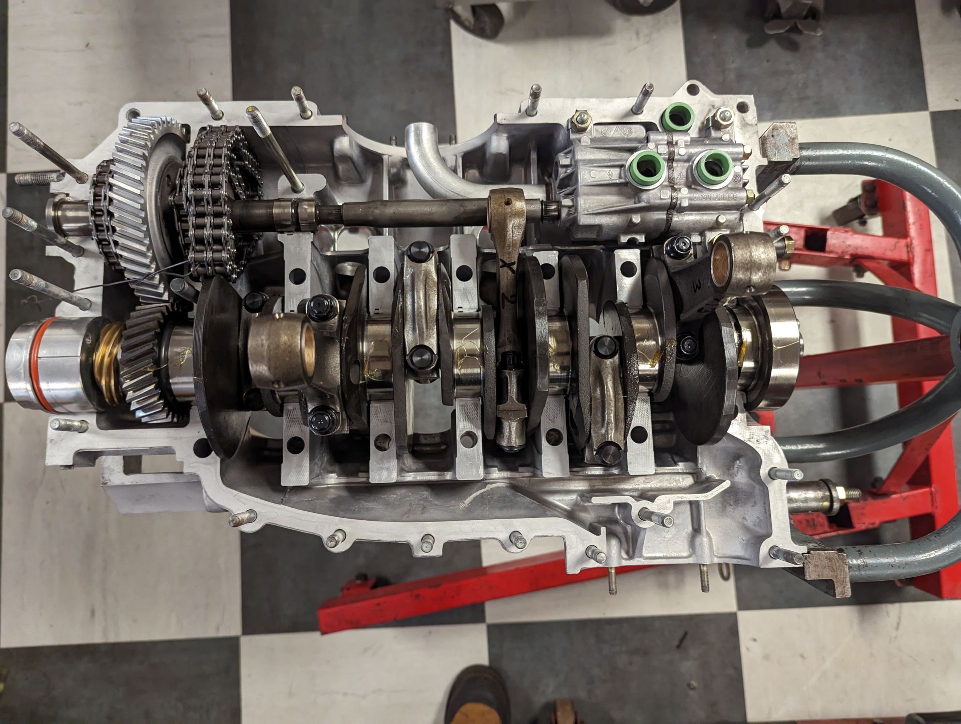 Disassembled car engine in a shop setting, showcasing internal components like the crankshaft and connecting rods. | Autobahn Performance