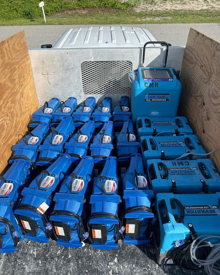 Technician operating extraction equipment in a severely flooded home